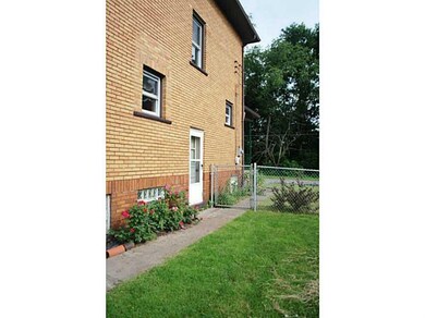 Exterior Back. Side yard view with door to basemen