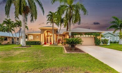 View of front of home with a garage and a lawn