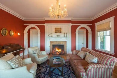 Front parlor with fireplace and twin...