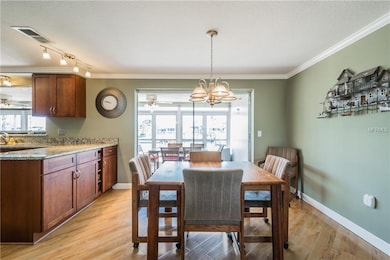 Dining area with gleaming wood laminate floors, cr