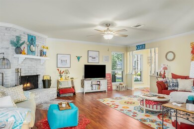 Living room featuring ceiling fan, a fireplace, da