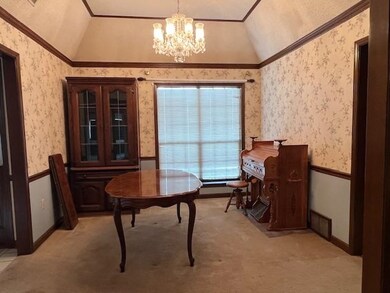 Interior space with a chandelier, lofted ceiling, 