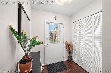 Doorway with wood finished floors and baseboards