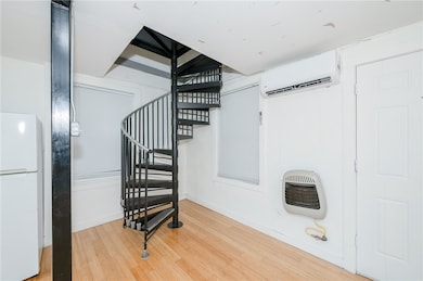 Stairs with baseboards, heating unit, wood finishe