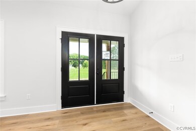 Foyer entrance featuring light hardwood / wood-style flooring and french doors