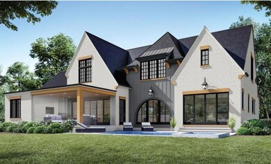 Rear view of property with a yard, board and batten siding, a patio area, and brick siding