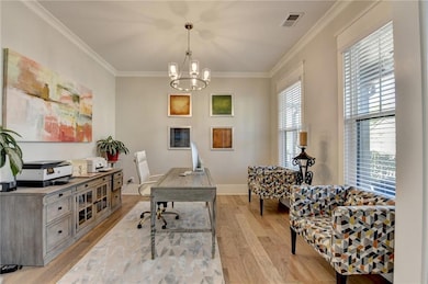 Office space featuring a chandelier, visible vents