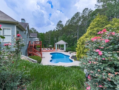 Outdoor pool with a patio, a gazebo, a wooden deck