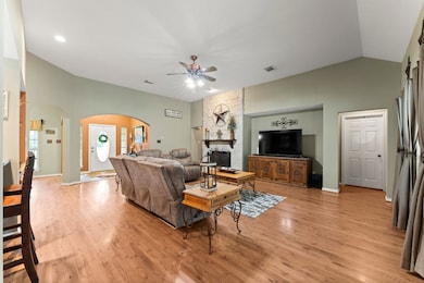Spacious living room with high ceilings, wood floo