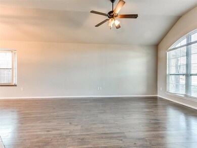 Spare room featuring ceiling fan, hardwood / wood-