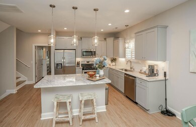 Kitchen featuring gray cabinets, backsplash, visib