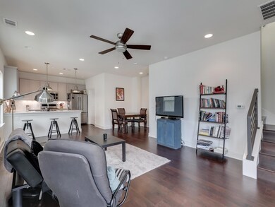 Living room featuring ceiling fan, dark wood-styl