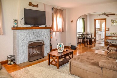 Living room with hardwood flooring and a fireplace