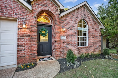 A charming curved walkway leads to the front entrance, bordered by thoughtfully landscaped beds with room to expand for seasonal flowers or vibrant accents.