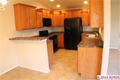 The large kitchen has in bar and beautiful applian