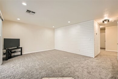 Family room with baseboards, visible vents, recess