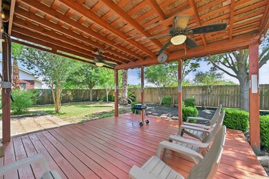 Spacious covered back patio featuring a ceiling fa
