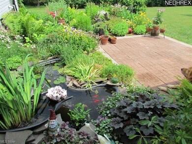 Landscaped backyard with fish pond.