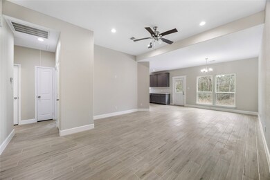 This spacious open-concept living area features mo