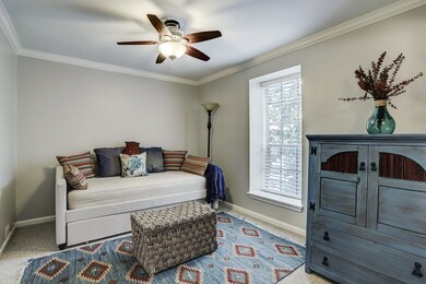 Second bedroom with large window, ceiling fan, en