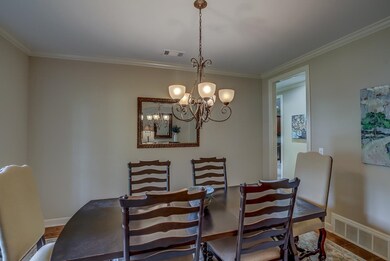 Dining space with a notable chandelier, wood-type 