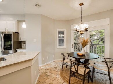 Dining room with an inviting chandelier, stone ti