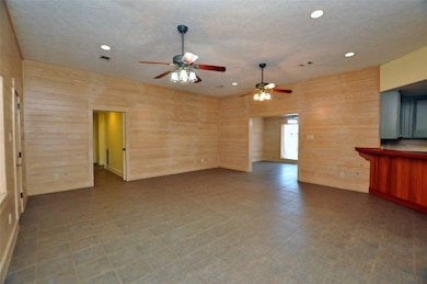 This spacious living area features warm wood panel