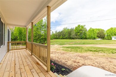 Wooden deck with a porch and a lawn