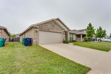 View of front of home with brick siding, an attached garage, and concrete driveway