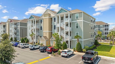 View of building exterior with uncovered parking and a residential view