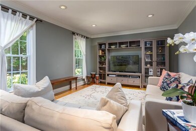 Lovely formal living room with hardwood floors, crown molding and recessed lights.