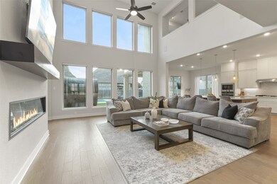 THE FAMILY ROOM FEATURES SOARING CEILINGS AND WALL