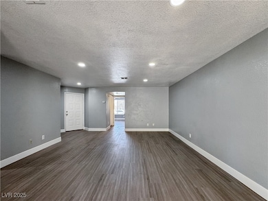 Unfurnished living room with a textured ceiling, d