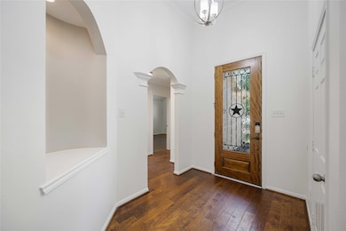 This photo shows a welcoming entryway with hardwoo
