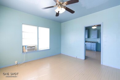 Empty room featuring ceiling fan, light hardwood /
