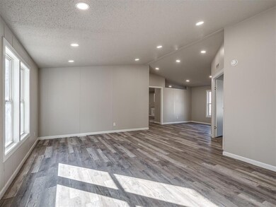 Empty room with dark hardwood / wood-style floors,