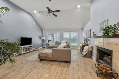 Another view of the living room with large windows to bring in natural light.