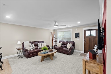 Living room with a ceiling fan, plenty of natural