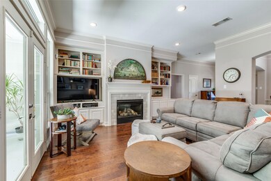 Living room with a tile fireplace, built in shelve