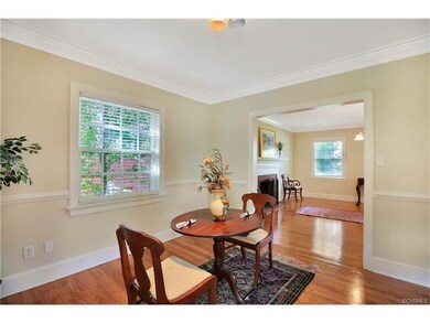 Dining room, with 3 pc crown molding, chair rail and refinished hardwood.