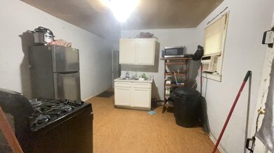Kitchen with stainless steel appliances, white cabinets, cooling unit, and a sink