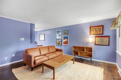 Living area featuring baseboards and wood finished