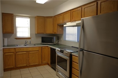 Kitchen with range and refrigerator.