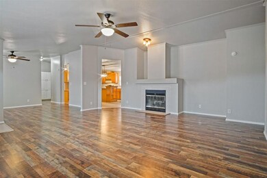 Large living room featuring fireplace, dark wood-l