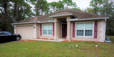 Front elevation showing outdoor lighting, rain cutters and two car garage. Home has impact windows and shutters for patio doors.
