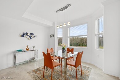 Dining space featuring ornamental molding and light tile patterned floors