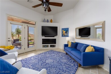 Living room featuring ceiling fan, tile patterned