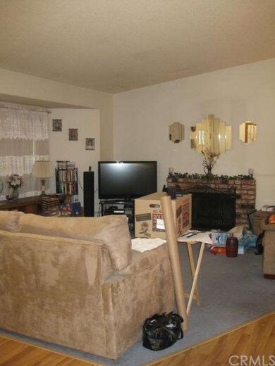formal living area w/ vaulted ceiling and brick fi
