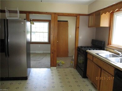 The kitchen features newer cabinetry and is adjace