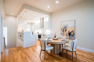 Dining room with recessed lighting, light wood fin